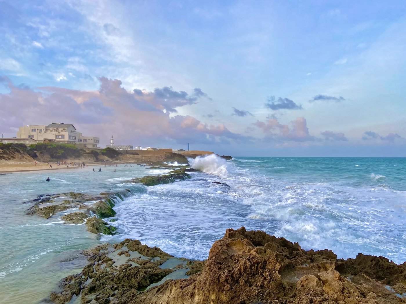 The Somali coastline at Mogadishu, with waves breaking on the rocks below a mosque and the shoreline